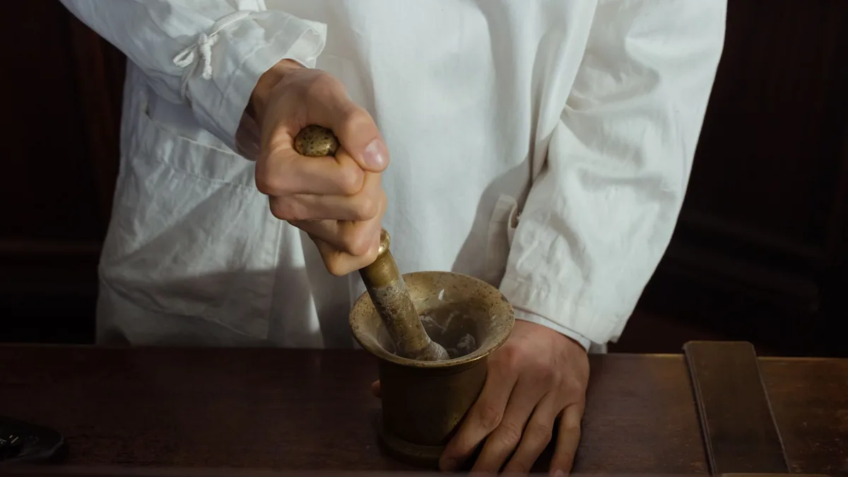 Pharmacist grinding ingredients using a mortar and pestle. Traditional pharmacy preparation. — Illustration accompanying a report on compounded tirzepatide facial nodules described in two dermatology journal letters