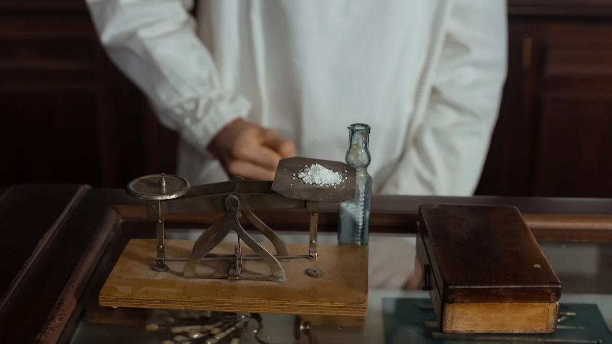 Pharmacist grinding ingredients using a mortar and pestle. Traditional pharmacy preparation. — Illustration accompanying a report on compounded tirzepatide facial nodules described in two dermatology journal letters