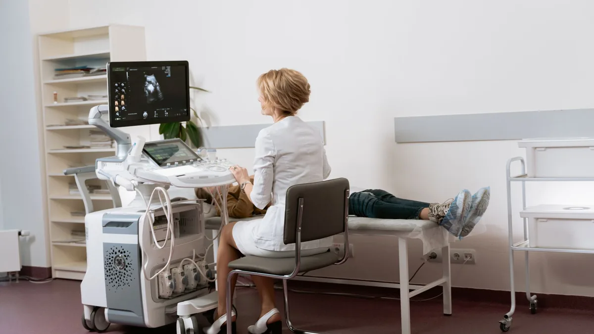 Doctor performing ultrasound scan on patient in modern clinic. — Illustration for a GLP-1 muscle loss study using DXA body composition scans and strength testing