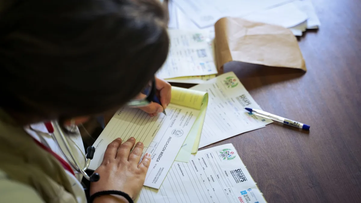 A doctor holds and reviews medical documents, demonstrating careful examination and professionalism. — Illustration accompanying coverage of the retatrutide cardiovascular outcomes trial reaching full enrollment