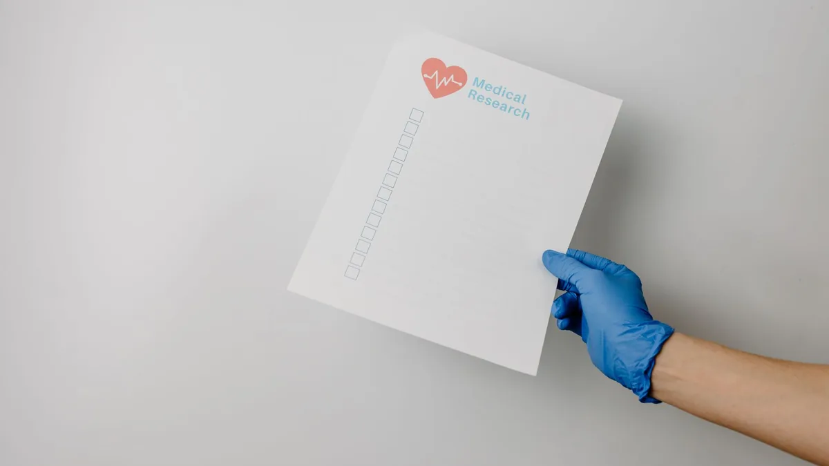 A gloved hand holding a paper titled 'Medical Research' with checkboxes. — Illustration accompanying coverage of semaglutide cognitive side effects research in a 13,007-patient cohort study