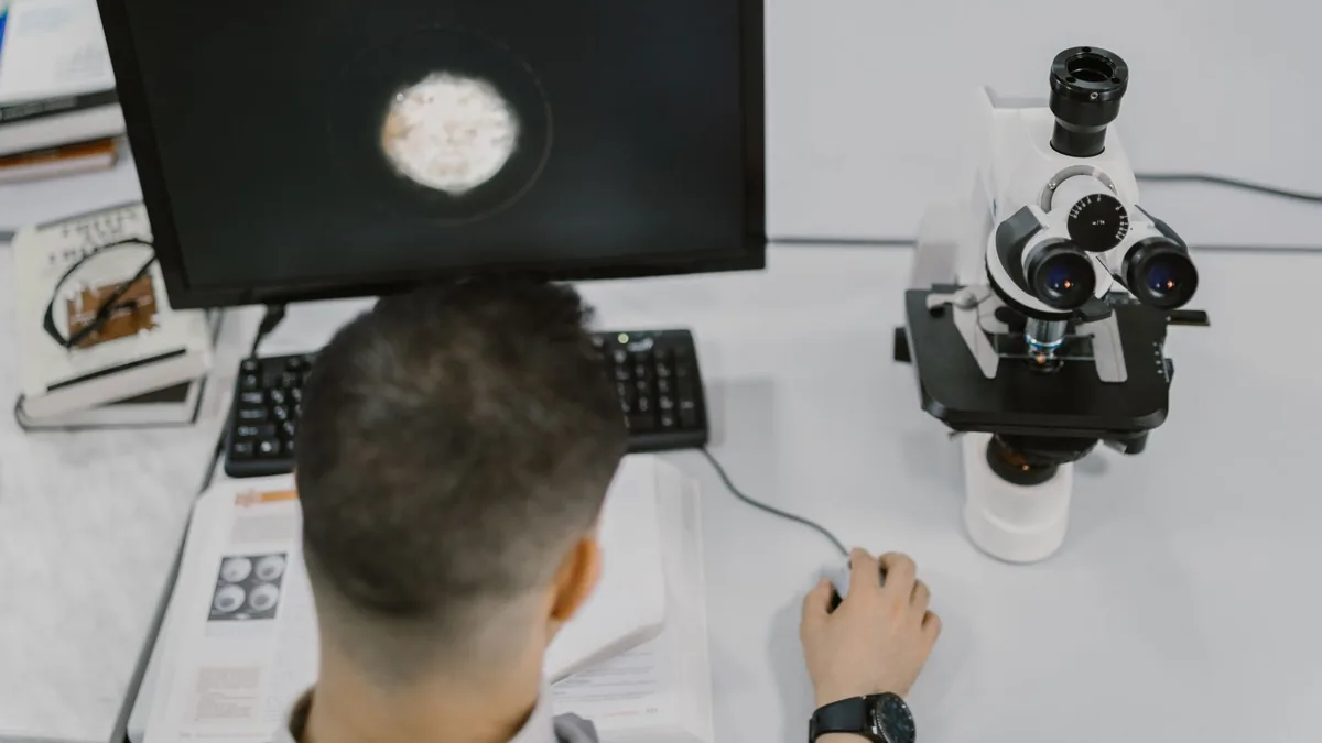 Scientist working with a microscope in a modern laboratory setup. — Illustration accompanying coverage of the semaglutide lifespan mice study published in Nature