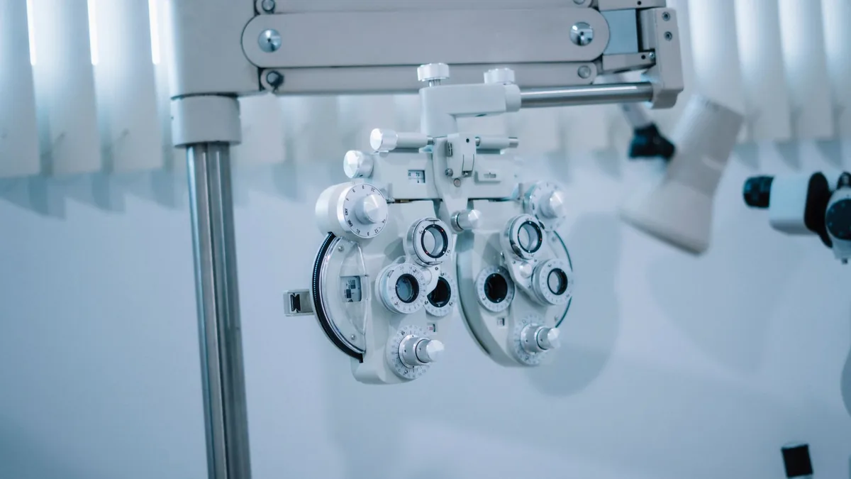 Detailed view of an optical phoropter in a modern eye clinic, used for testing vision clarity. — Illustration accompanying a report on tirzepatide eye side effects described in a new eyelid case series